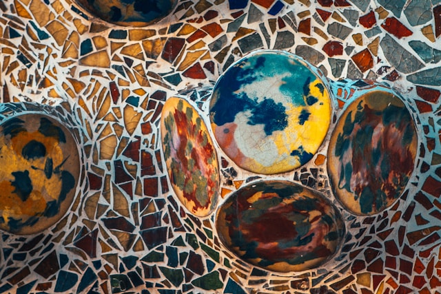 Circular mosaic with earth-toned tiles, by Ester, age 6.